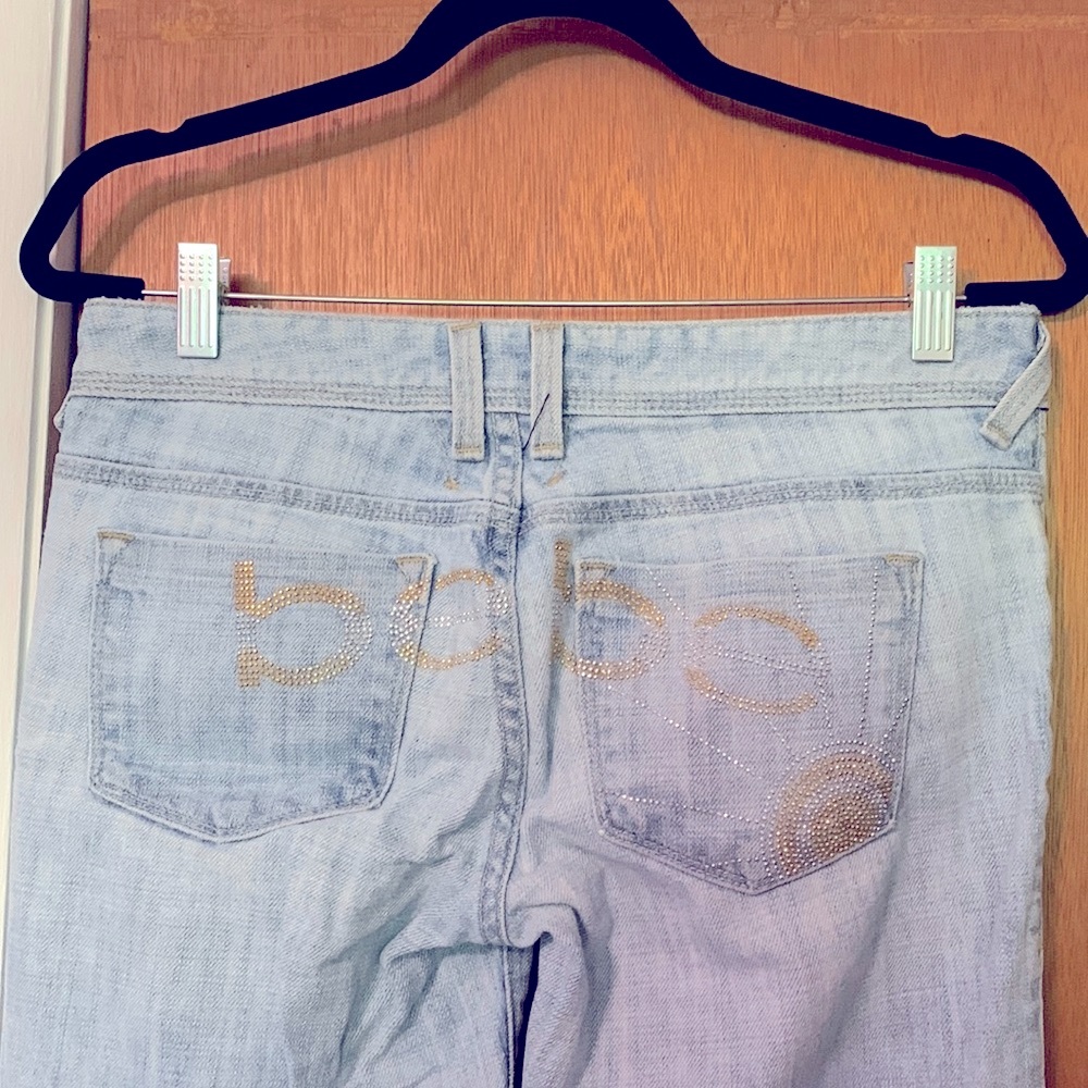 Bebe light colored flare jeans with beaded design on back. Size 28.